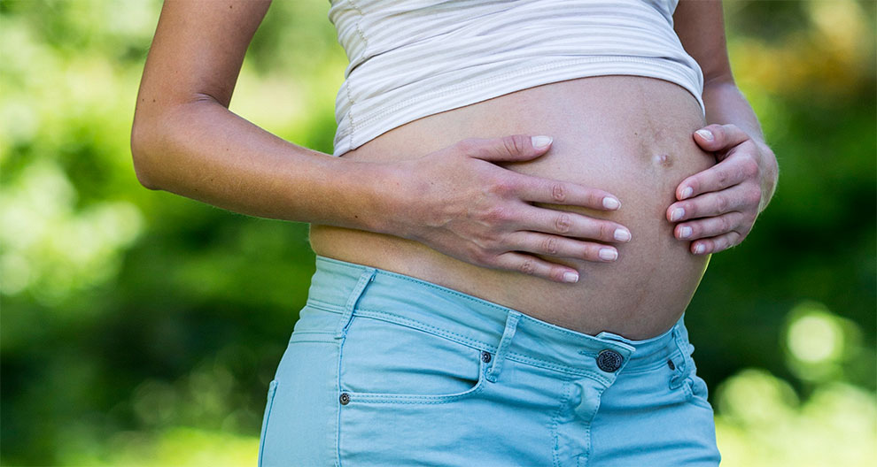 A pregnant woman outdoors.
